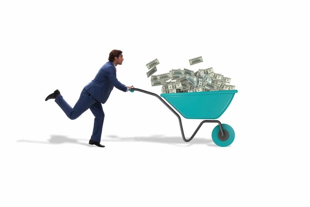 A Richest Trader pushing a wheelbarrow full of money