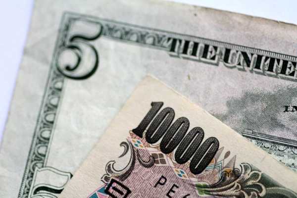 Dollar gains on Fed rate hike bets, yen dips on Ueda comments